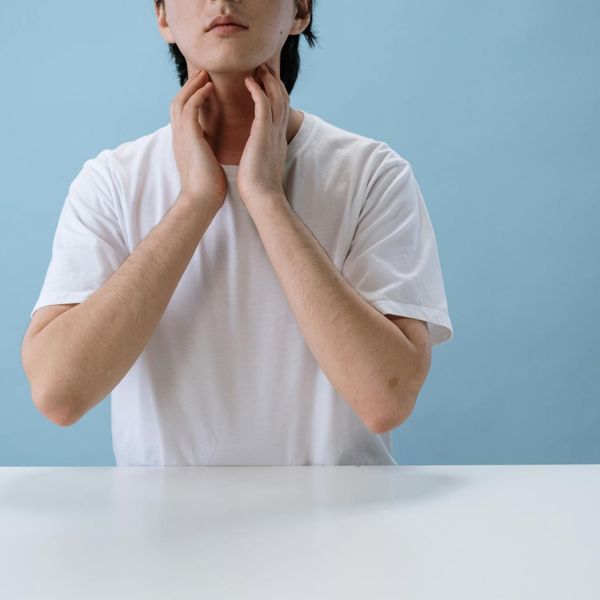 Person in a balanced, calm pose against a minimalist background.